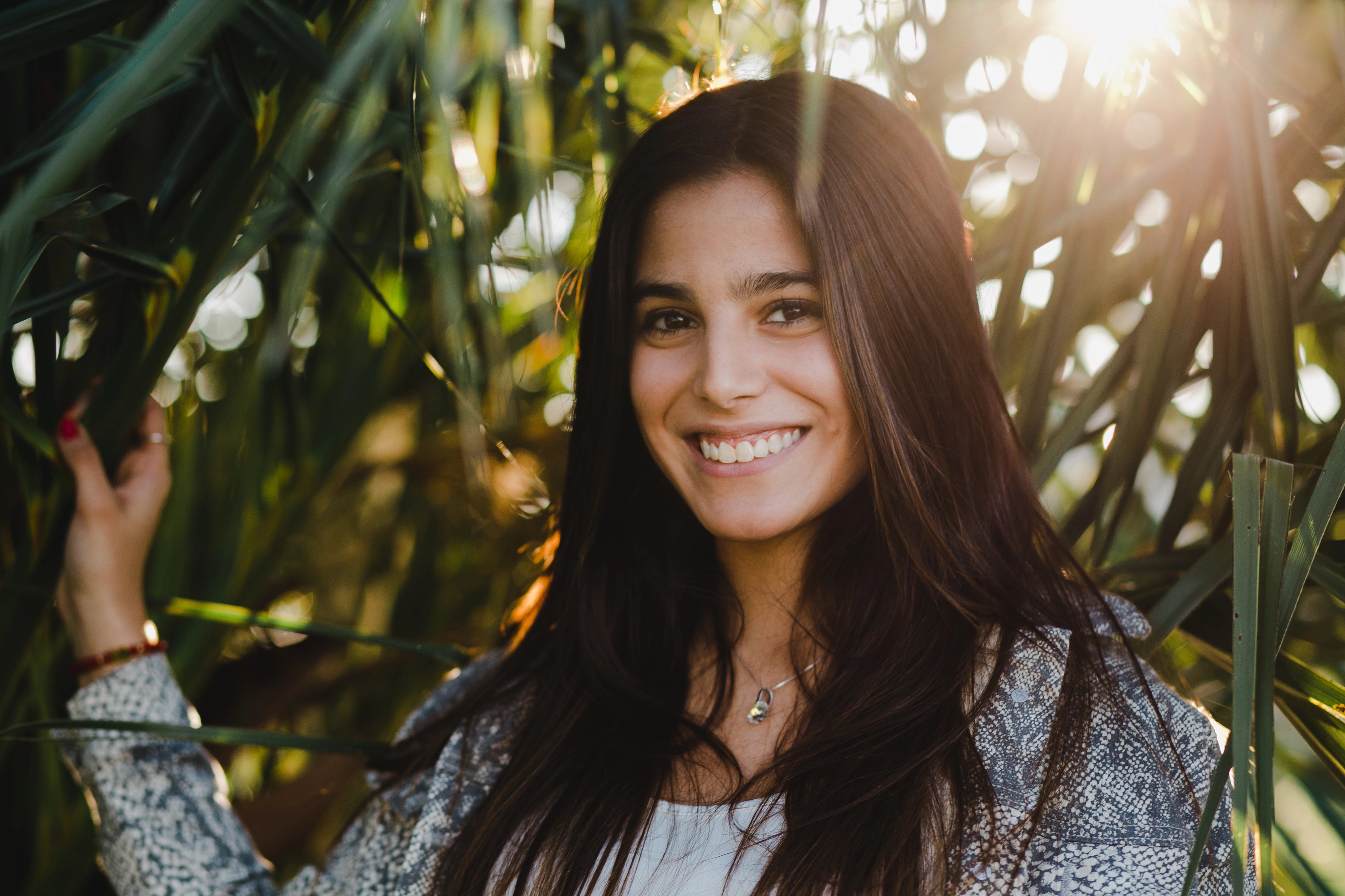 files/portrait-smiling-teenage-girl-standing-against-trees-park_1.webp